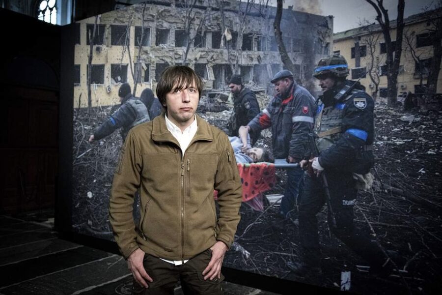 Winnaar Evgeniy Maloletka staat bij zijn winnende foto van een zwanger
slachtoffer van een raketinslag in Marioepol.