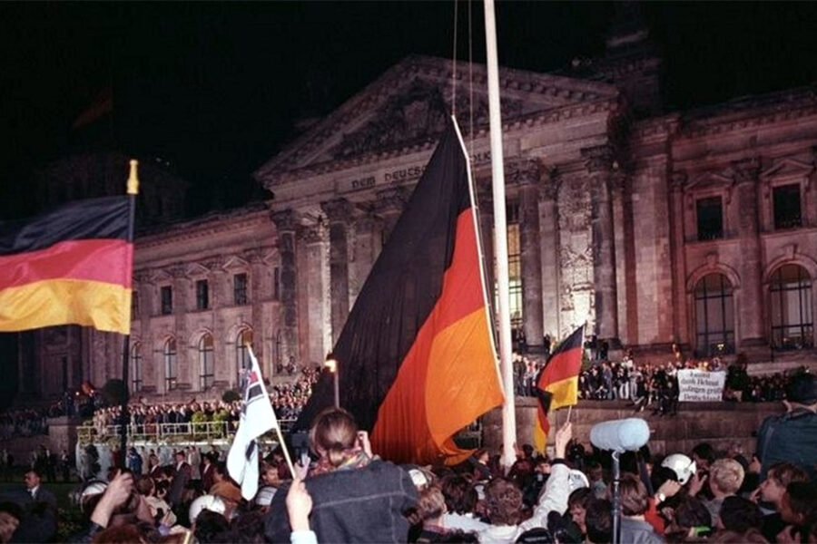 Een sfeerbeeld van 3 oktober 1990, mensen komen samen voor de Reichstag in
Berlijn.